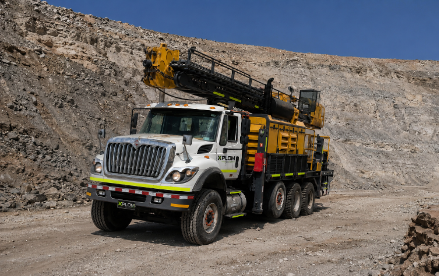 XPLOM truck-mounted drill rig in open-pit mine