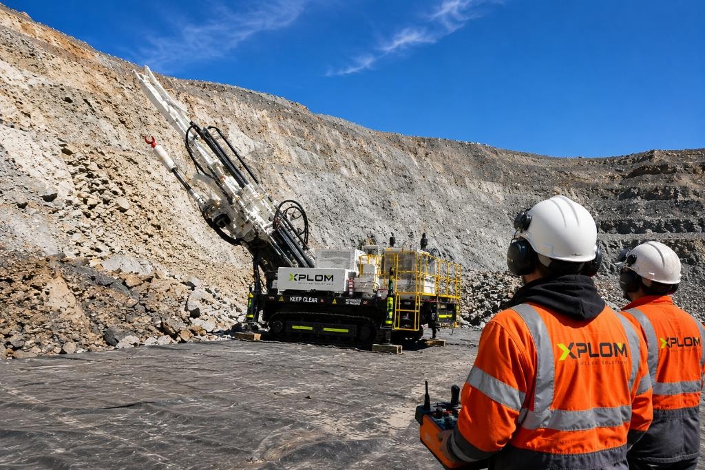 XPLOM crew operating subhorizontal RC rig on open pit mine face