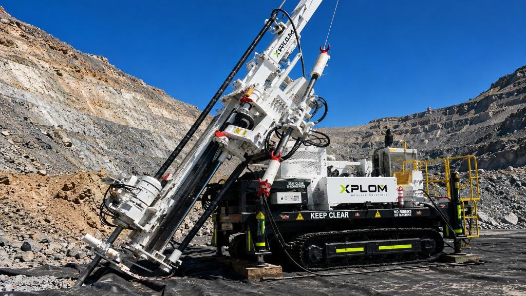 XPLOM subhorizontal RC drilling rig at inclined angle on open pit wall